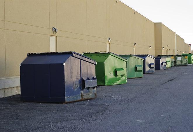 brightly colored dumpsters filled with construction waste in Aromas, CA